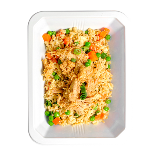 This is small container loaded with a fried rice dish containing brown rice, chicken thigh, peas, carrots, and green onions.  It looks like food a healthy meal prep service would cook in order to supply their customer base with healthy, flavorful food options.