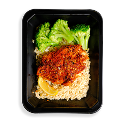 This salmon looks so tasty.  It is heavily seasoned with a red seasoning and is served on top of brown rice accompanied by three pieces of broccoli and a lemon wedge.  This meal is packaged in a to-go container which makes me think this is a healthy meal prepared and sold to people on to go or people who like to have healthy prepared meals delivered to their hous.