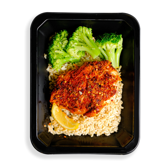 This salmon looks so tasty.  It is heavily seasoned with a red seasoning and is served on top of brown rice accompanied by three pieces of broccoli and a lemon wedge.  This meal is packaged in a to-go container which makes me think this is a healthy meal prepared and sold to people on to go or people who like to have healthy prepared meals delivered to their hous.