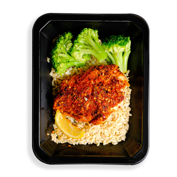 This salmon looks so tasty.  It is heavily seasoned with a red seasoning and is served on top of brown rice accompanied by three pieces of broccoli and a lemon wedge.  This meal is packaged in a to-go container which makes me think this is a healthy meal prepared and sold to people on to go or people who like to have healthy prepared meals delivered to their hous.