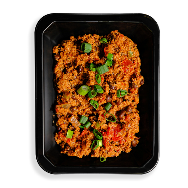 a very robust portion of chili fills this black togo container with green onion sprinkled lightly on top. this looks very appetizing and is clearly designed for people who want to watch what they eat while not sparing themselves any of the flavor of good eating.