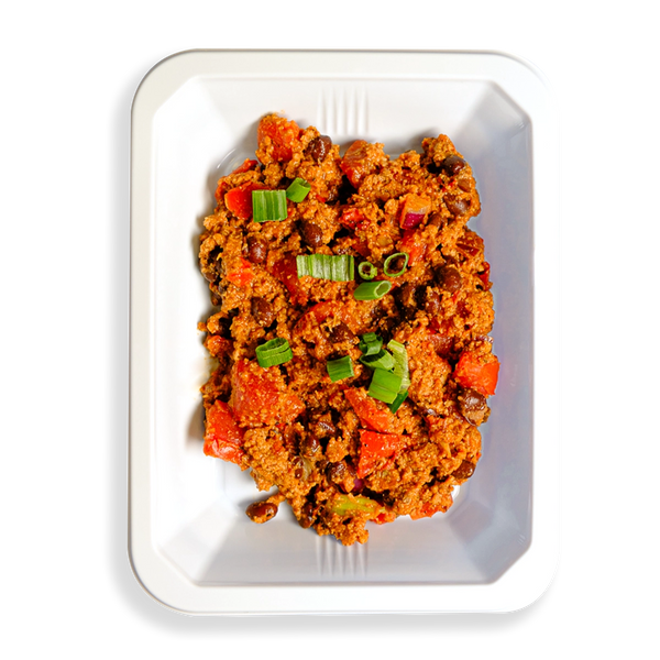 A hearty serving of chili fills this black to-go container, garnished with a light sprinkle of fresh green onions. This flavorful and satisfying meal is crafted for those who prioritize healthy eating without compromising on taste.