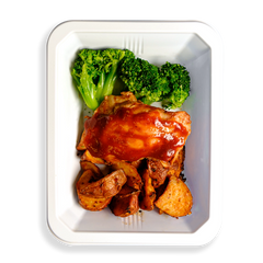 One piece of BBQ chicken, approximately three pieces of very green broccoli and many red potatoes fill this white container.  The container as a whole is a to-go meal for people who want to eat healthy but do not want to deprive themselves of flavor.