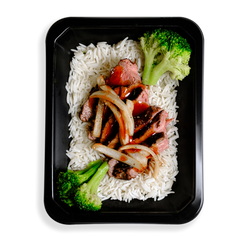 Thinly sliced flank steak over white rice, topped with low-sodium teriyaki sauce, broccoli, and julienned onions occupies the space of a black togo container.  The broccoli is very green and this healthy prepared meal appears to be for those who are mindful of what they eat while not wanting to spare flavor and quality eating.