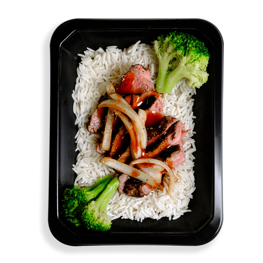 Thinly sliced flank steak over white rice, topped with low-sodium teriyaki sauce, broccoli, and julienned onions occupies the space of a black togo container.  The broccoli is very green and this healthy prepared meal appears to be for those who are mindful of what they eat while not wanting to spare flavor and quality eating.