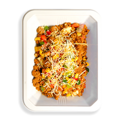 Hearty and vibrant scramble with ground turkey, egg whites, roasted veggies, and cheese—fuel for active, health-conscious lifestyles. This food fills a white togo container and appears to be for people who want to eat well while still eating clean healthy prepared foods.