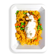 This to-go container is packed with vibrant, fresh ingredients—fluffy couscous loaded with green peas and bright orange carrots, all topped with tender chicken drizzled in a creamy white sauce. The bold colors and appetizing presentation make it an ideal choice for someone on the go who wants a healthy, flavorful meal without sacrificing convenience or taste.