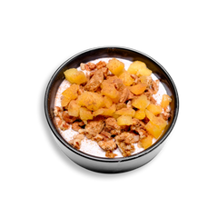 A three quarter view of a nutrient-dense yogurt parfait served in a sleek black bowl, brimming with health-conscious ingredients. The smooth Greek yogurt base is swirled with cinnamon and agave, then topped with juicy peach chunks, crisp granola, and rich pecan pieces. The contrast of textures and warm spice notes makes this a visually appetizing and wholesome option for those seeking a high-protein, low-fat healthy prepared meal.