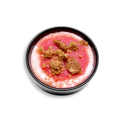A 3/4 view of a vibrant bowl featuring a swirl of creamy Greek yogurt sweetened with agave nectar, layered beneath a bright pink strawberry-pineapple purée. Topped with clusters of golden-brown granola for crunch, this colorful, fruit-forward healthy prepared meal is a refreshing and protein-packed option for clean eating or breakfast meal prep.