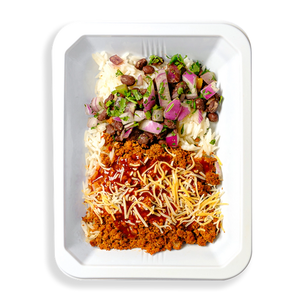 This white container is filled with what looks like the contents typically seen in a taco or burrito.  This is a healthy prepared meal designed for people focusing on their healthy but not wanting to part ways with flavorful eating.
