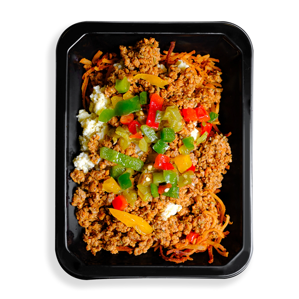 A black to-go container filled with scrambled eggs, seasoned ground pork, shredded hash browns, and a colorful topping of peppers and green chilies. This healthy prepared meal is for those who are very busy and want food delivered while still focusing on eating very clean.