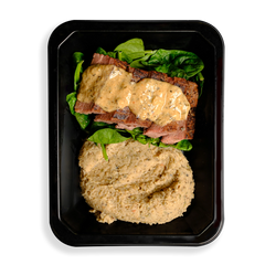 Sliced flank steak drizzled with creamy peppercorn sauce, resting on fresh spinach with a side of smooth herbed white bean purée, all neatly packed in a black to-go container.  The fact that this food looks so healthy and is packaged for delivery or instore pickup makes me think this is for busy people who want to eat well but are not always able to cook.